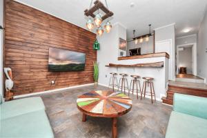 a living room with a table and a bar at Gulf Siesta Vacation Lofts in Galveston