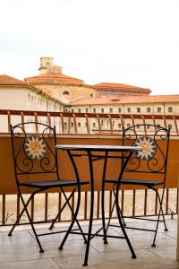 a table and two chairs sitting on a balcony at CLavi Apartament in Sassari