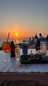 a table with a plate of food and a drink on the beach at Il Giardino Segreto in Maglie