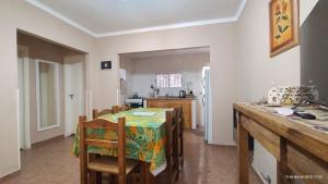 a kitchen with a table and chairs in a kitchen at Punto Sur Departamentos in Tandil