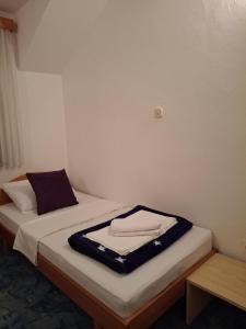a room with a bed with a coat on it at Restoran Prenociste As in Trnovo