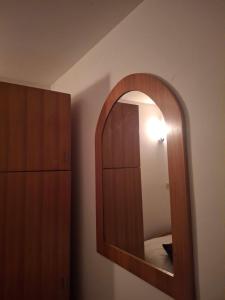 a mirror on a wall in a room at Restoran Prenociste As in Trnovo