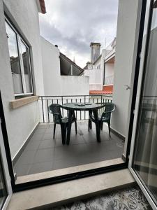 a patio with a table and chairs on a balcony at TemplarDreams - Old Centre in Tomar +31 photos