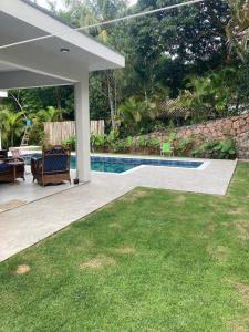 a backyard with a swimming pool and a lawn at casa em Ihabela in Ilhabela +31 photos