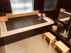 a pool of water in a bathroom with a sink at Nara Ryokan in Nara