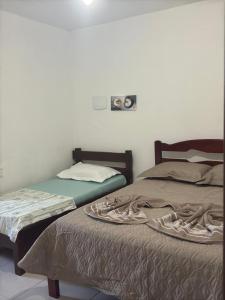 Кровать или кровати в номере Recanto do Leco - Praia da Armação