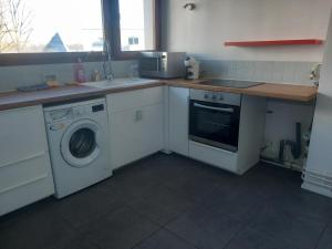 a kitchen with a washing machine and a sink at T3 act in Pessac