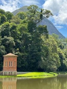 a brick building sitting in the middle of a lake at Apartamento familiar no centro em Nova Friburgo in Nova Friburgo