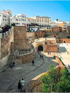 a group of people walking around a city at DAR TAZROUT in Tangier