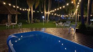 a blue tub sitting on a wooden deck with lights at Chalé Paradiso Biazolli in Farroupilha