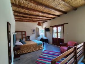 a bedroom with a bed and a couch at Balconcito de Colores in Maimará