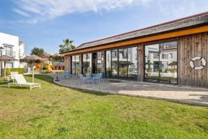 a building with a patio with tables and chairs at Luxury family apartment with breathtaking views in Marbella
