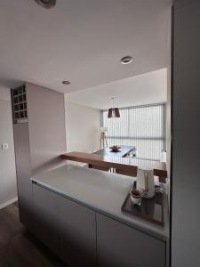 a kitchen with white walls and a counter top at Semipisos Balcarce in Balcarce +24 photos