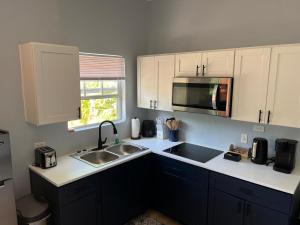 a kitchen with a sink and a microwave at Sunburst Studio in Turtle Cove