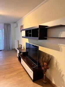 a living room with a flat screen tv on a wall at Home Guest - Apartment 1 in Oradea
