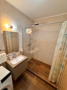 a bathroom with a sink and a shower at Home Guest - Apartment 1 in Oradea +17 photos
