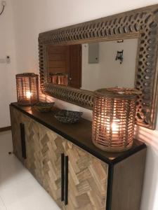 a table with two lights and a mirror on it at Luxury penthouse , Nilaveli, Srilanka in Nilaveli