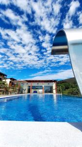 a view of a swimming pool in front of a house at Pousada Rancho dos Ipês in Alto Paraíso de Goiás