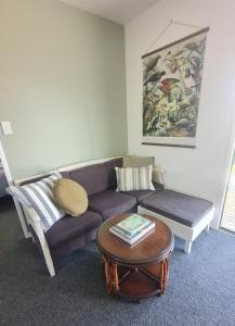 a living room with a couch and a coffee table at The Kraken Cottage in Whitianga