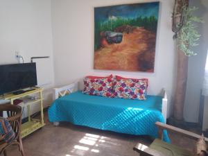 a room with a bed and a painting on the wall at Casitas del Cerro in Chacras de Coria +42 photos