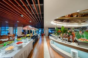 a buffet line in a restaurant with food on display at Poly Hotspring Guiyang Hotel in Guiyang