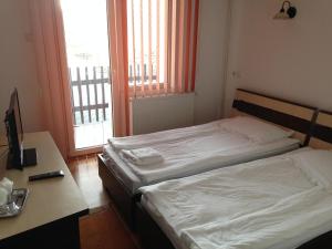 Postel nebo postele na pokoji v ubytování Hotel Romantik