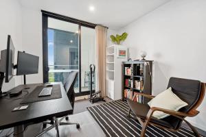 an office with a desk with a computer and a chair at Riverina - Ultimate Footscray Getaway with parking in Melbourne +14 photos