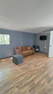 a living room with a couch and a television at Cabañas del Escultor Cabaña Canelo in Valdivia +14 photos