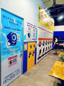 a laundry room with a washer and dryer at Riveria City near KL Sentral with 118 view Sky Infinity Pool by COBNB in Kuala Lumpur +84 photos