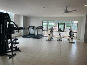 a gym with several treadmills and machines in a room at MANIS EVO SoHo BANGI - WIFI, NETFLIX, SHOPPING MALL in Bandar Baru Bangi +9 photos
