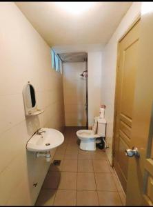 a small bathroom with a toilet and a sink at Ummu's homestay in Tanah Rata