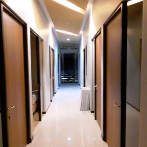 a hallway of a hotel with a long corridor at Phoenix Living in Surabaya +1 photo