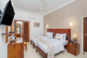 Letto o letti in una camera di Hotel Travellers Nest Kandy