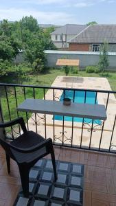 a table and a chair on a balcony at Ismayilli Guest House in İsmayıllı +45 photos