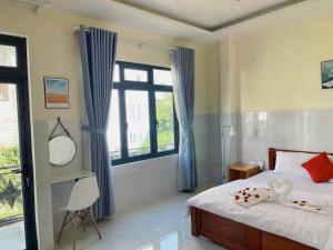 a bedroom with a bed and a large window at Nhà Nâu Homestay DL- by BAY LUXURY in Da Lat