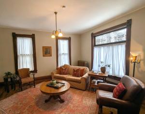 a living room with a couch and a table at The John Sydney House in Hannibal