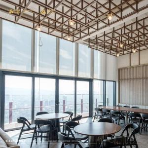 a room with tables and chairs and large windows at Agile Pavillion TRX Luxury Suited Kuala Lumpur Good View in Kuala Lumpur