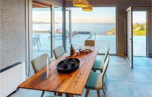 a wooden table in a room with a view of the ocean at Stunning Home In Gazi, Heraklio in Lygaria