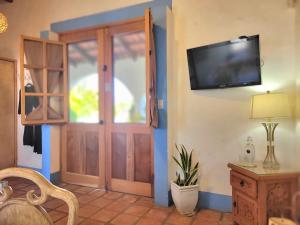 a room with a door and a television on the wall at Casa Magdalena in San Carlos