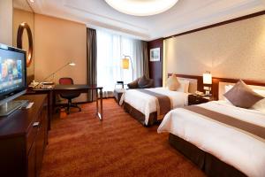 Postel nebo postele na pokoji v ubytování Central Hotel Shanghai - Nanjing Road + 37 fotografií