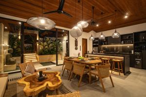 a kitchen and dining room with a table and chairs at Villa Kemalasan by BaliSuperHost in Ubud