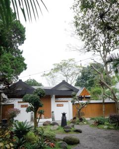 a house with a garden in front of it at Lavana Villa by Raminten in Yogyakarta