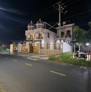 a motorcycle parked in front of a house at night at Nhà Nâu Homestay DL- by BAY LUXURY in Da Lat +1 photo