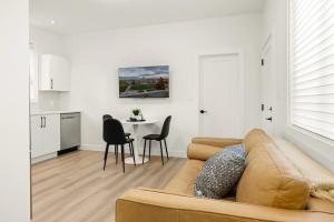 a living room with a couch and a table at Cozy Saanich Cottage ideal location to UVIC and Downtown in Victoria +4 photos