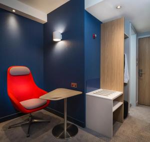 a room with a chair and a desk at Holiday Inn Express St. Albans - M25, Jct.22 in St. Albans