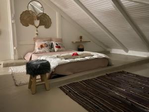 a bedroom with a bed in a attic at L'isménia, Le Loft in Le Gosier