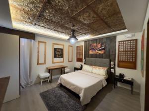 a bedroom with a bed and a desk in it at Armando's Garden Resort and Restaurant in Anao +28 photos