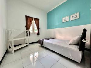 Ένα ή περισσότερα κρεβάτια σε δωμάτιο στο Omah Lestari