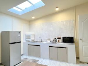a kitchen with a refrigerator and a microwave at Wonderful inn in Pattaya +19 photos