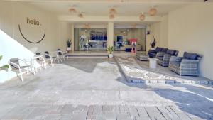 a lobby with chairs and tables in a store at Wonderful inn in Pattaya